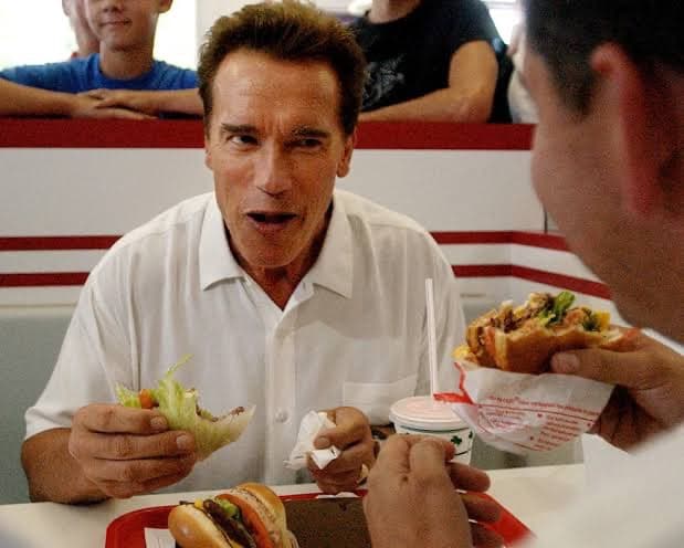 Two people talking across a fast-food booth